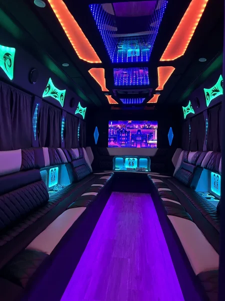 Party Bus - Neon lounge with wraparound leather seating and TV - Dallas VIP Transportation